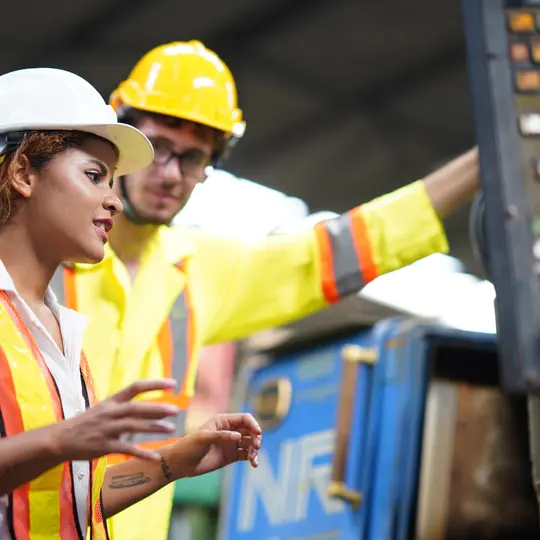 Female engineer working with machinery in the factory