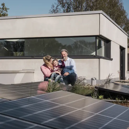 Father with daughter points to energy-efficient electrical solutions at their home