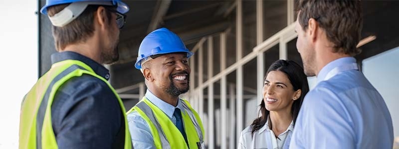 A group of people wearing safety vests and helmets