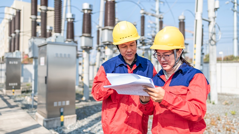 Power engineer checking electrical equipment at substation