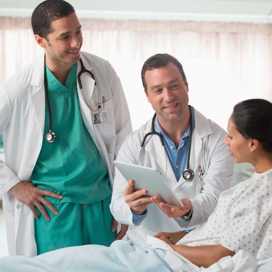 A doctor and nurse looking at a tablet