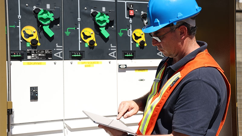 A person wearing a hard hat and safety vest