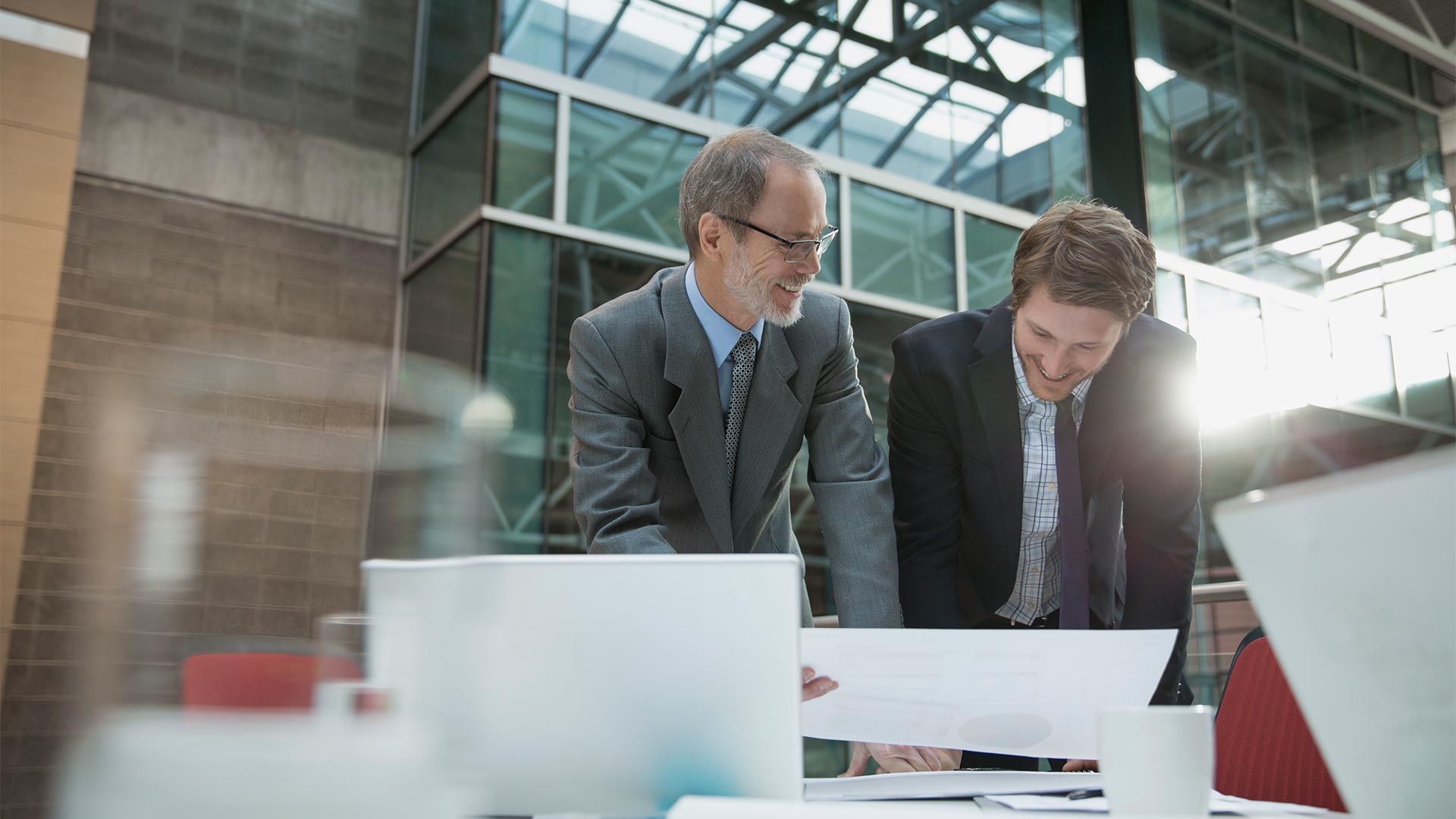 two businessmen talking and smiling