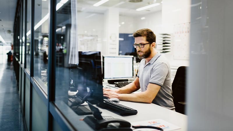 A person sitting at a desk using a computer