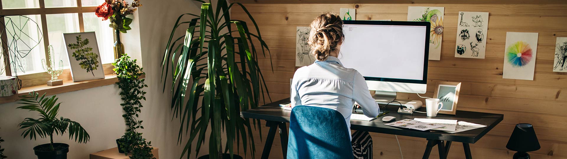 Woman working on her desktop computer at home office