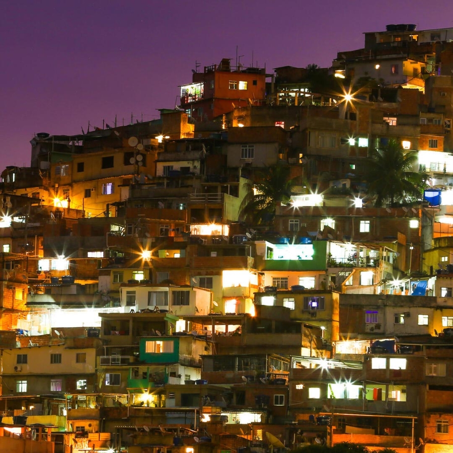 Illuminated Residential Buildings Against Sky At Night