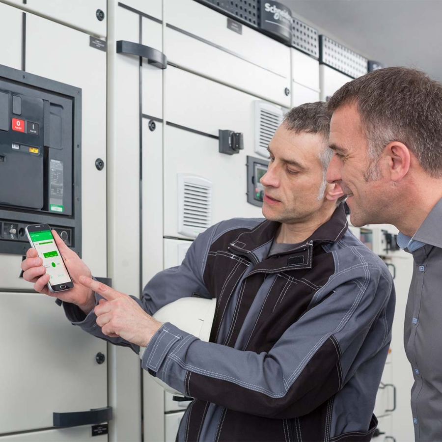 Men looking at a phone in a room