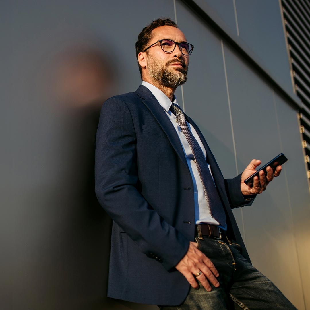 A person in a suit holding a phone