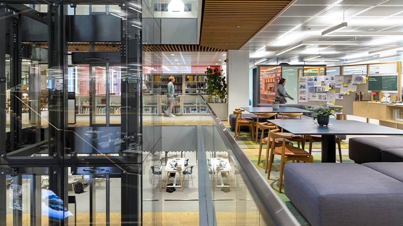 A glass wall with tables and chairs