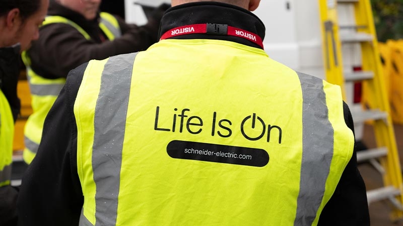 A person wearing a yellow jacket