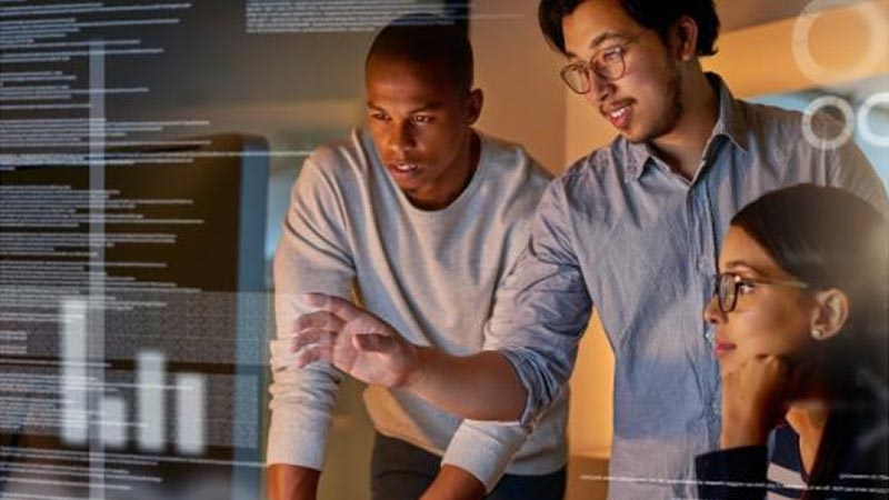 A couple of men looking at a computer screen