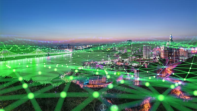 A city with green lines and dots