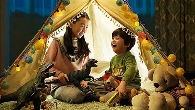 kids playing with toys on house tent
