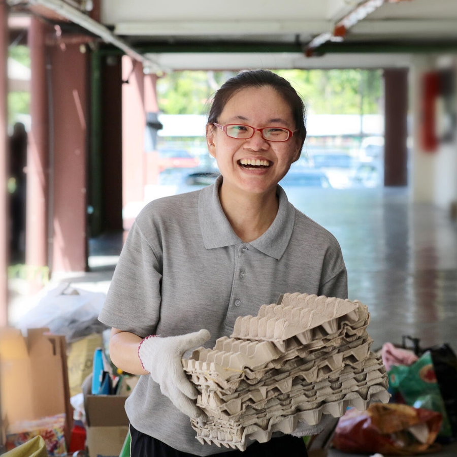 A female adult is volunteering for neighbourhood recycling programme