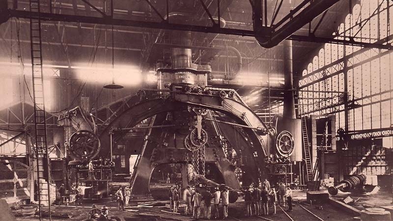 A group of people standing around a machine