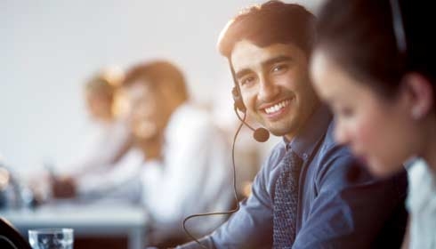 Businessman wearing headset in office, sustainability consulting