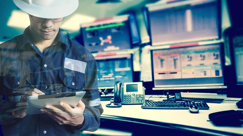 A person in a hard hat using a tablet