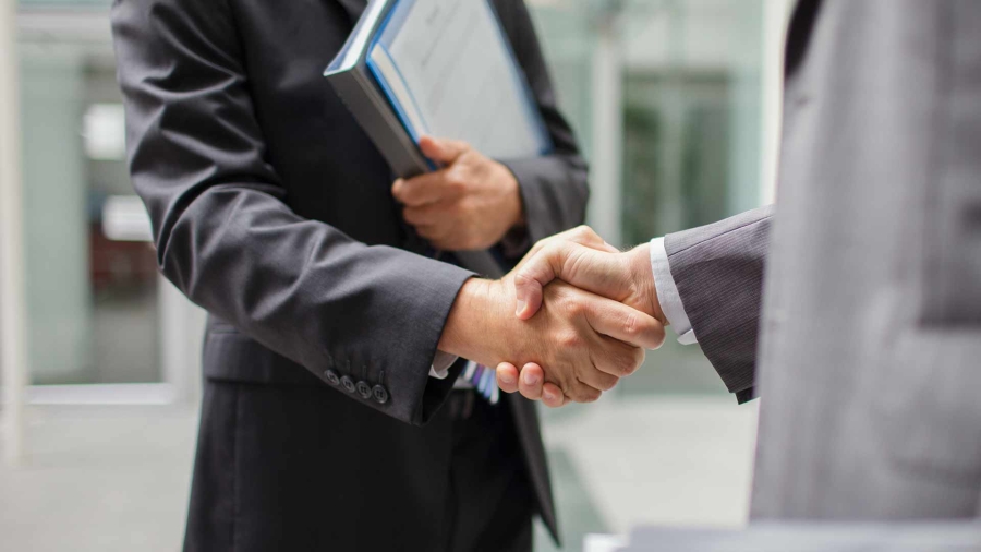 Closeup of two men shaking hands with each other