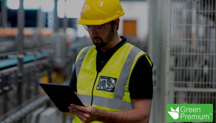 An engineer wearing safety hat and holding a digital tablet in hand