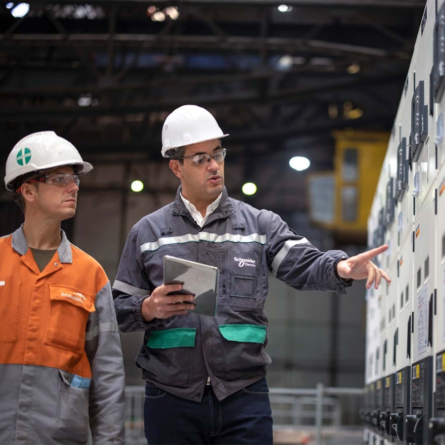 two men discussing and walking panel board