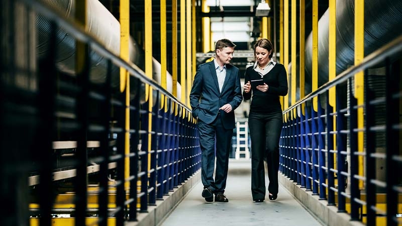 A person and person walking down a hallway