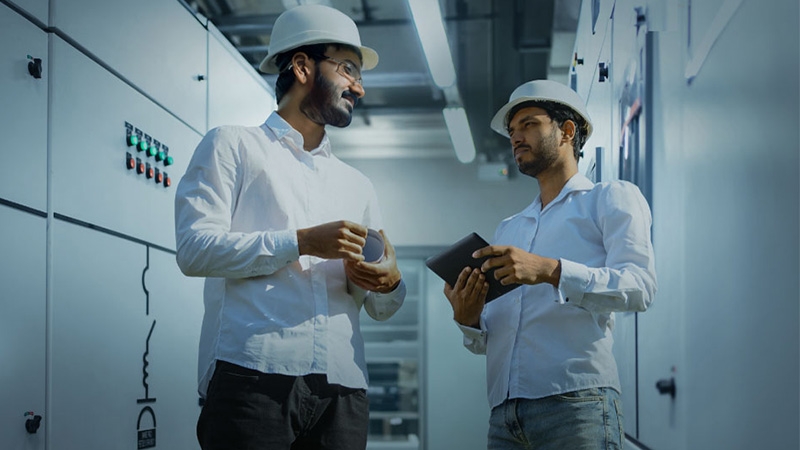 Two co workers discussing something in the factory