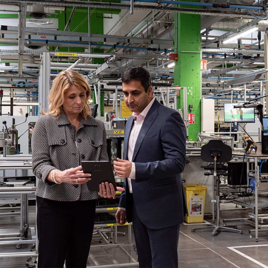 A person and person looking at a tablet