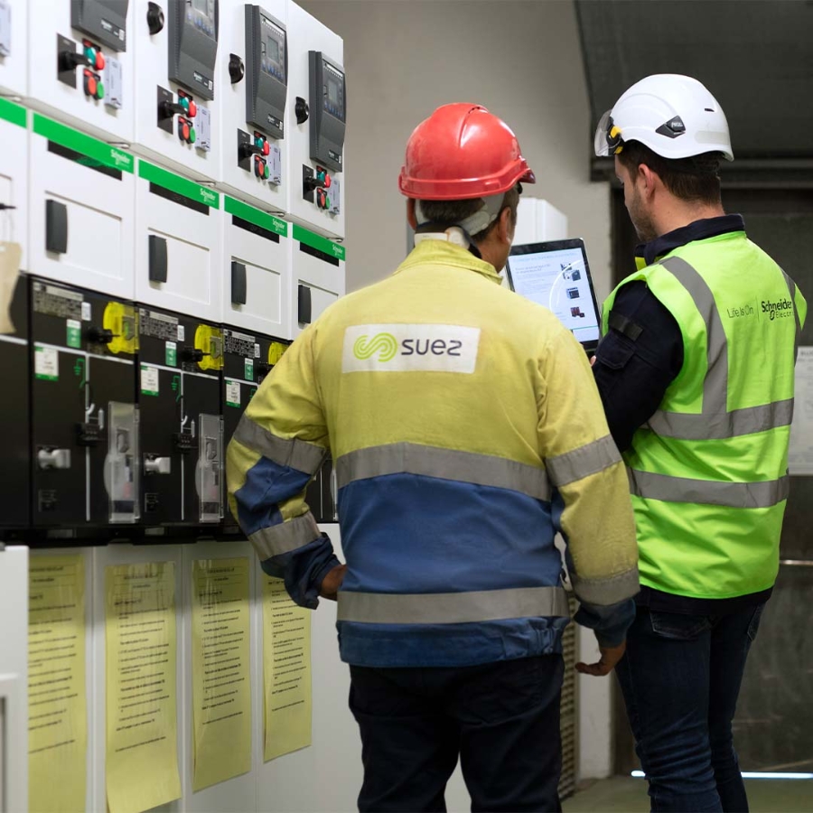 A group of men wearing safety vests and helmets