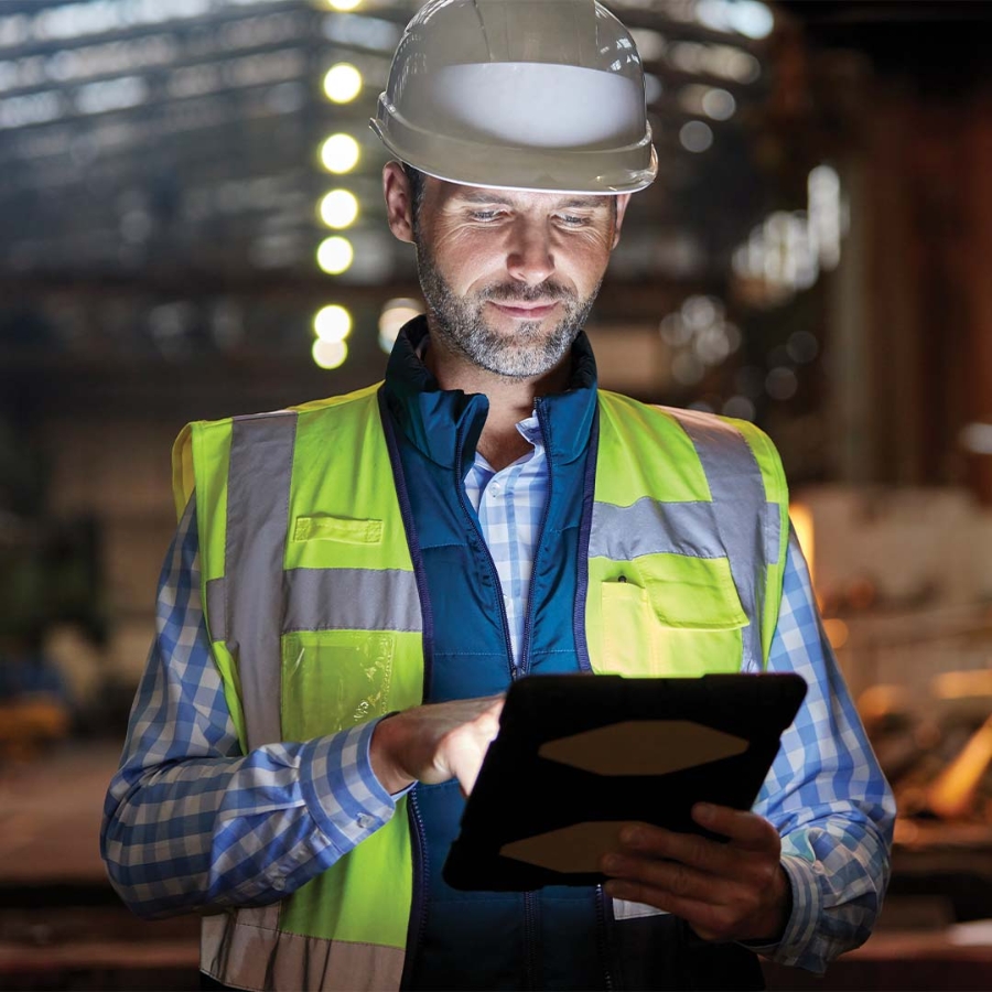 A person wearing a safety vest and hardhat