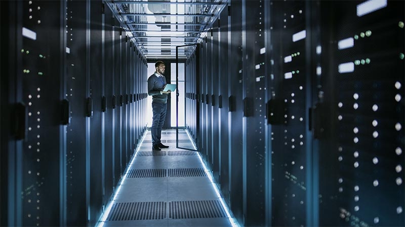 An employee assessing the IT infrastructure in the automotive manufacturing plant