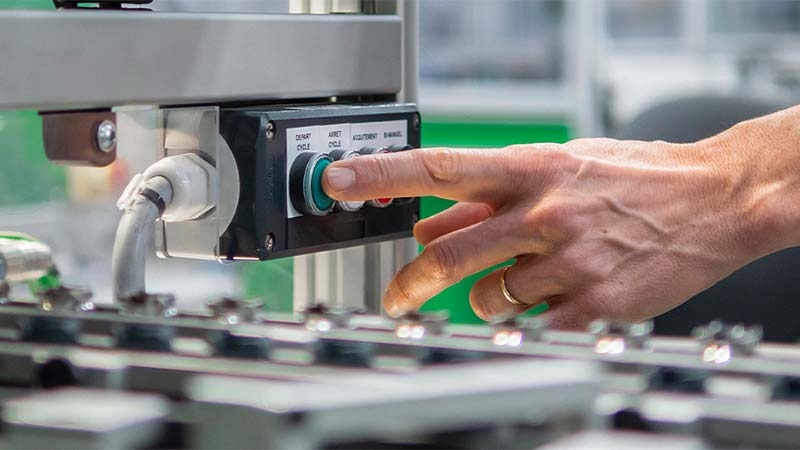 A person pressing a button on a machine