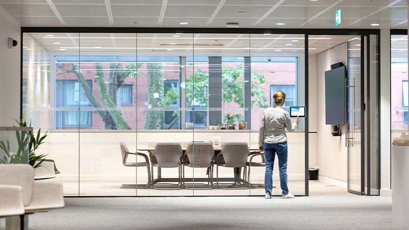 A person standing in front of a glass wall