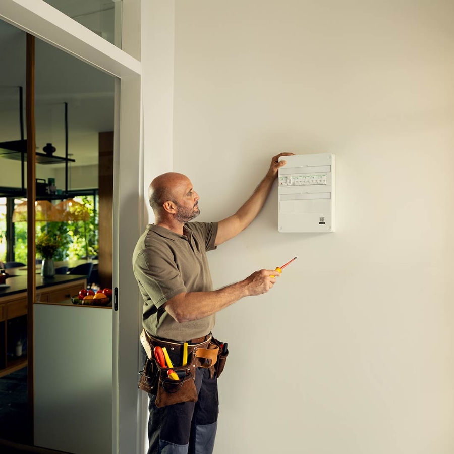 Electrician installing a panel