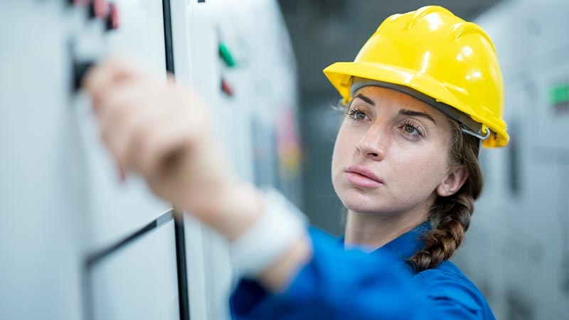 Service technician performing electrical distribution maintenance