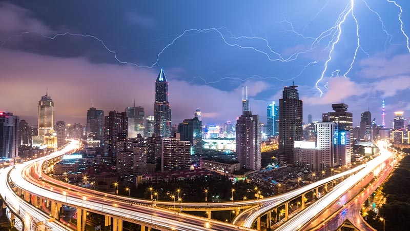 Lightning lighting in the sky over a city