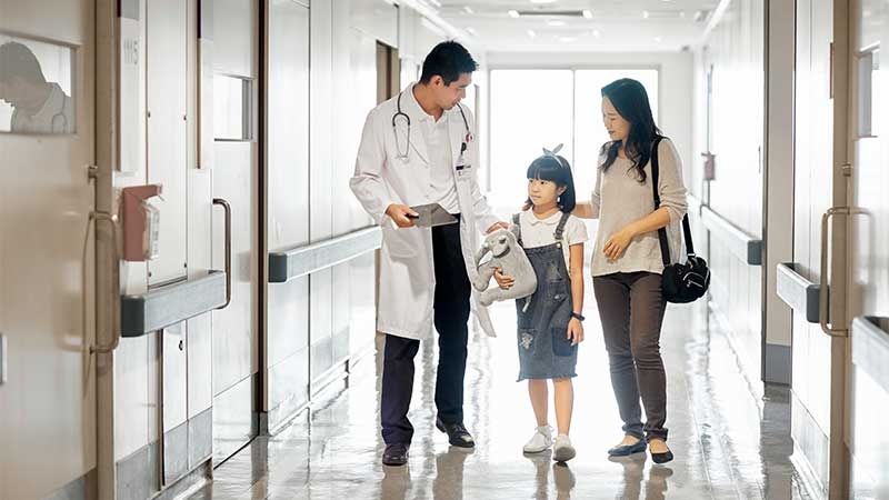 A doctor talking to a young child