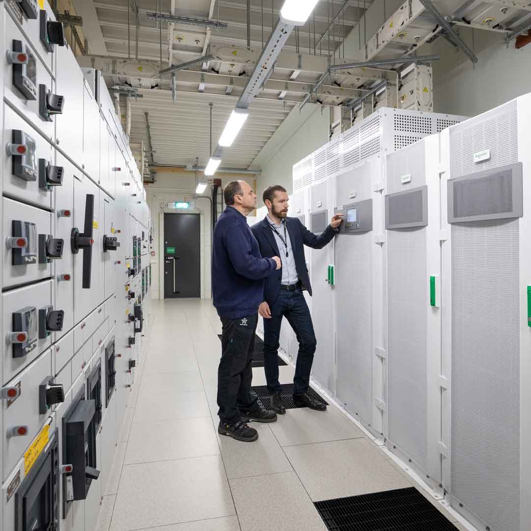 two male engineers are in Data center server room 