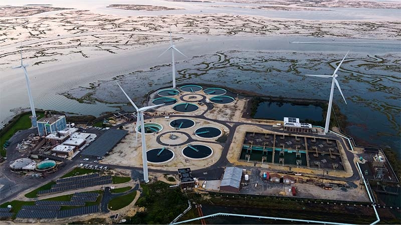 A windmills in a circle surrounded by water