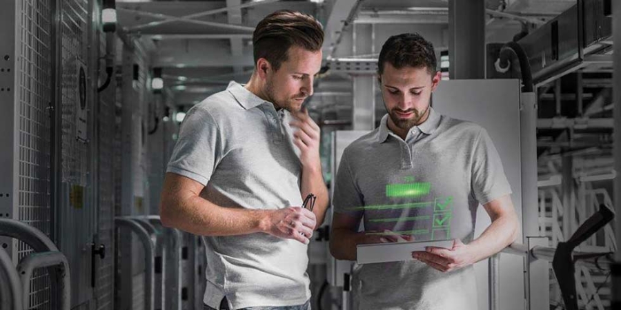 Two men in automated high rack warehouse looking at tablet