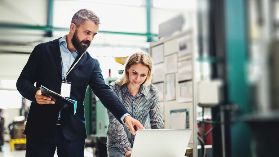 A person and person looking at a computer