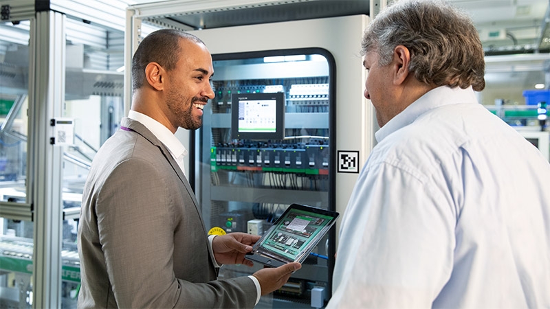 Two men talking with each other in a factory