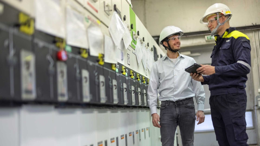 A person in a white helmet standing next to another person in a white helmet