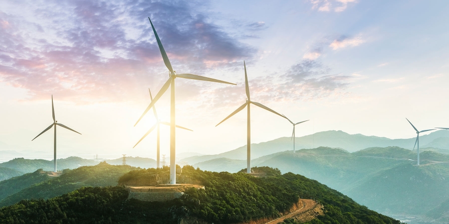 white wind mills in the forest during daytime