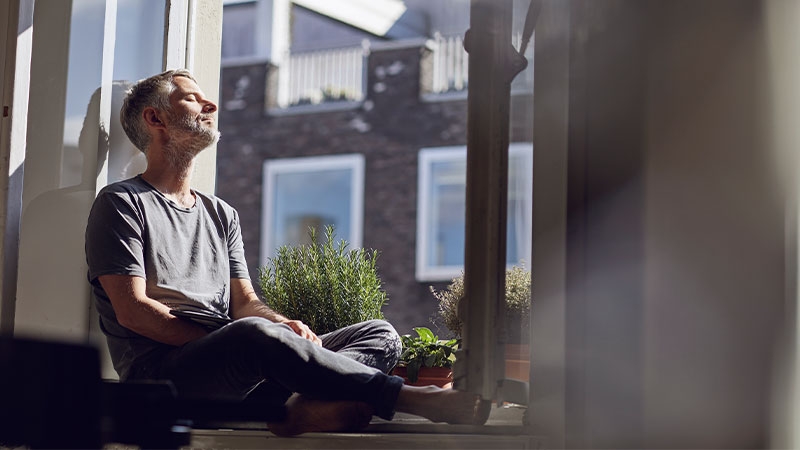 A person sitting on a window sill