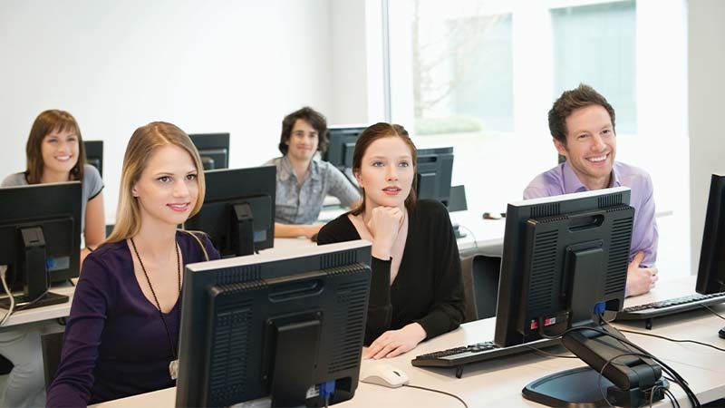 A group of people working in a computer room