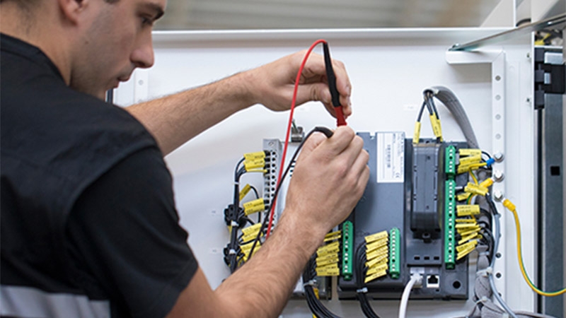 technician customizing part of medium voltage equipment