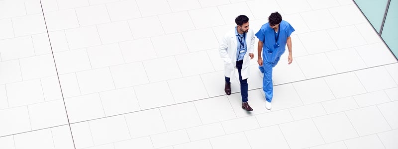 A group of people walking on a white surface