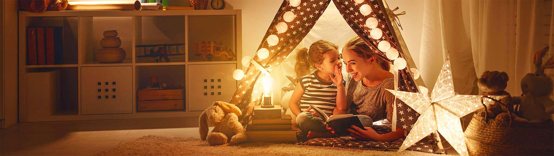 Two girls sitting in a tent