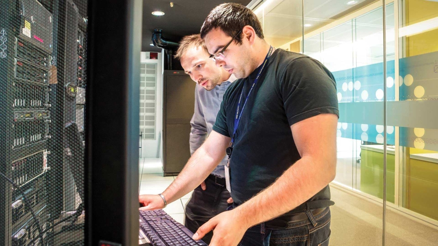 two chinese men working in the data center