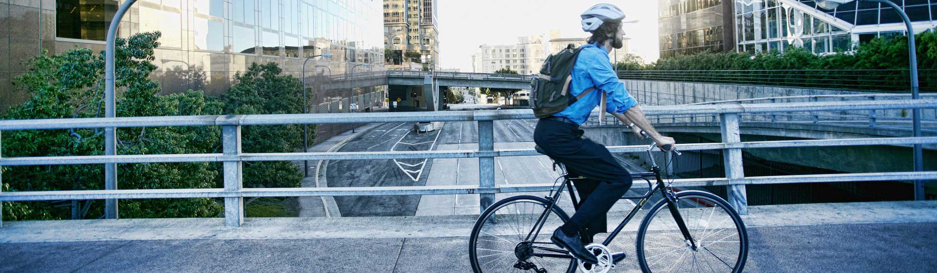 A man cycling over a bridge